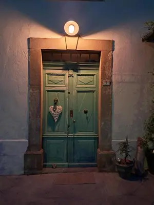 a green door in a building with a light on top at Chez Estelle Le SOL in Tourouzelle