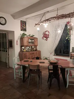 a dining room with a wooden table and chairs at Chez Estelle Le SOL in Tourouzelle