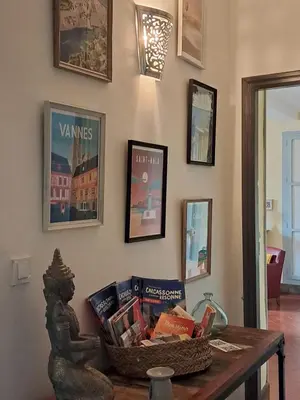 a basket of books on a table in a room at Chez Estelle Le SOL in Tourouzelle
