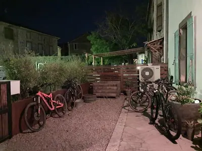 a group of bikes parked next to a house at night at Chez Estelle Le SOL in Tourouzelle