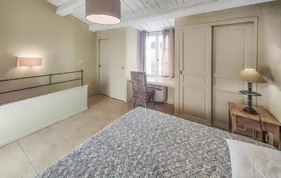 a bedroom with a bed and a desk and a table at Awesome Home In Saint-Laurent-De-La-Ca With Wifi in Saint-Laurent-de-la-Cabrerisse