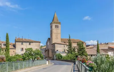 an empty road in a town with a church at Awesome Home In Saint-Laurent-De-La-Ca With Wifi in Saint-Laurent-de-la-Cabrerisse