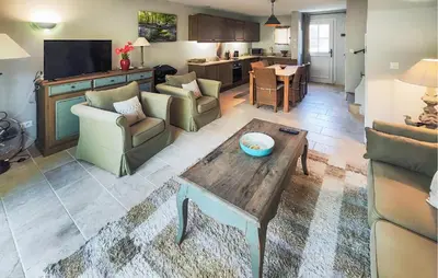 a living room with couches and a coffee table at 2 Bedroom Awesome Home In Saint-Laurent-De-La-Ca in Saint-Laurent-de-la-Cabrerisse