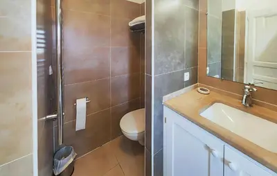 a bathroom with a toilet and a sink at 2 Bedroom Awesome Home In Saint-Laurent-De-La-Ca in Saint-Laurent-de-la-Cabrerisse