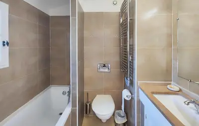 a bathroom with a toilet and a tub and a sink at 2 Bedroom Awesome Home In Saint-Laurent-De-La-Ca in Saint-Laurent-de-la-Cabrerisse