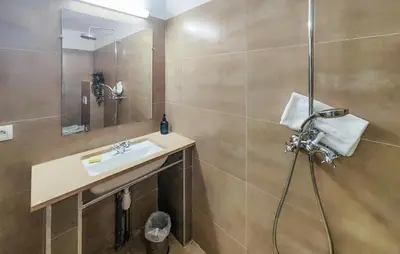 a bathroom with a sink and a shower at Amazing Home In Saint-Laurent-De-La-Ca in Saint-Laurent-de-la-Cabrerisse