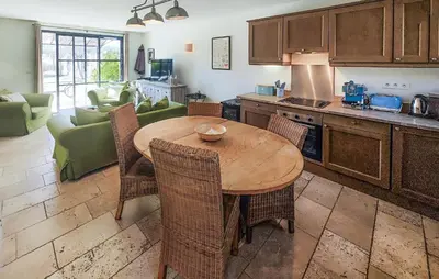 a kitchen with a wooden table and chairs in a room at Amazing Home In Saint-Laurent-De-La-Ca in Saint-Laurent-de-la-Cabrerisse
