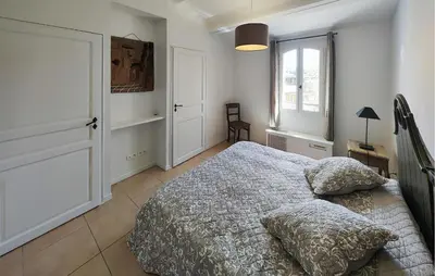 a bedroom with a bed and a window at 2 Bedroom Awesome Home In Saint-Laurent-De-La-Ca in Saint-Laurent-de-la-Cabrerisse