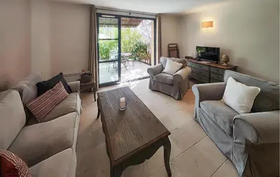 a living room with couches and a coffee table at 2 Bedroom Awesome Home In Saint-Laurent-De-La-Ca in Saint-Laurent-de-la-Cabrerisse