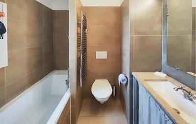 a bathroom with a toilet and a tub and a sink at 2 Bedroom Awesome Home In Saint-Laurent-De-La-Ca in Saint-Laurent-de-la-Cabrerisse
