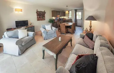 a living room with a couch and chairs and a table at 2 Bedroom Awesome Home In Saint-Laurent-De-La-Ca in Saint-Laurent-de-la-Cabrerisse