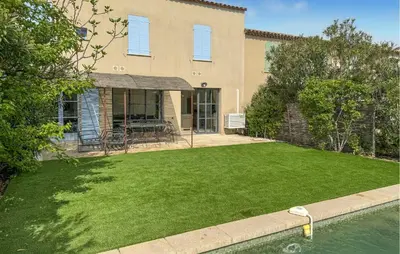 a house with a lawn and a pool at Nice Home In Saint-Laurent-De-La-Ca in Saint-Laurent-de-la-Cabrerisse