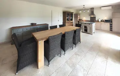 a kitchen with a long wooden table and chairs at Nice Home In Saint-Laurent-De-La-Ca in Saint-Laurent-de-la-Cabrerisse