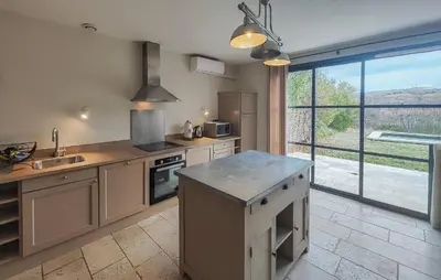 a kitchen with a counter and a large window at Nice Home In Saint-Laurent-De-La-Ca in Saint-Laurent-de-la-Cabrerisse