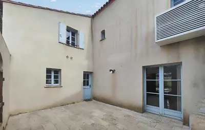 a building with two doors and a patio at Nice Home In Saint-Laurent-De-La-Ca in Saint-Laurent-de-la-Cabrerisse