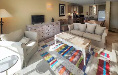a living room with two couches and a coffee table at Stunning Home In Saint-Laurent-De-La-Ca in Saint-Laurent-de-la-Cabrerisse