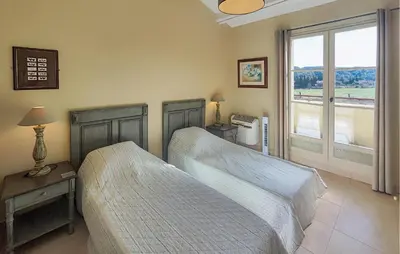 a bedroom with two beds and a window at Stunning Home In Saint-Laurent-De-La-Ca in Saint-Laurent-de-la-Cabrerisse