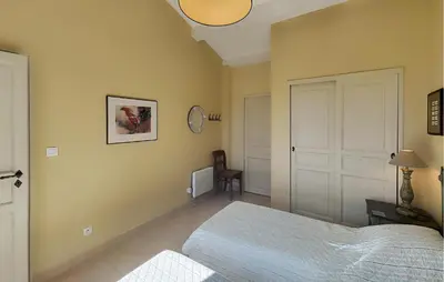 a bedroom with a bed and a clock on the wall at Stunning Home In Saint-Laurent-De-La-Ca in Saint-Laurent-de-la-Cabrerisse