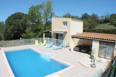 a villa with a swimming pool and a house at Gîte Les Amandiers in Villedubert