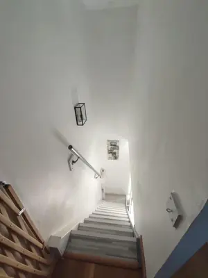 a stairway with a light and a stair case at Gîte Les Amandiers in Villedubert