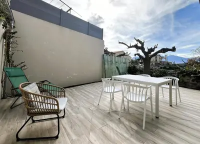 a white table and chairs on a patio at La Caseta de Molitg in Molitg les Bains