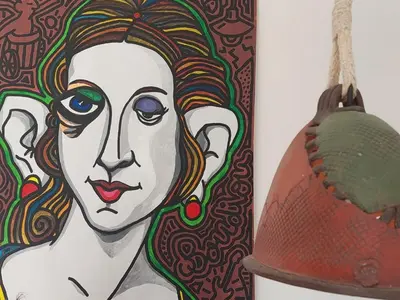 a painting of a woman and a helmet at La Caseta de Molitg in Molitg les Bains