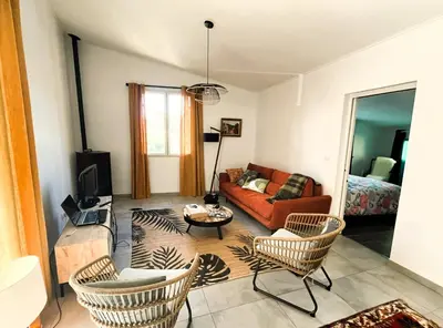 a living room with a couch and chairs at La Caseta de Molitg in Molitg les Bains