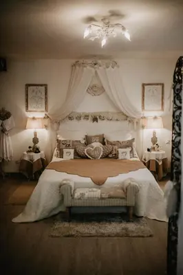a bedroom with a large bed with a chandelier at Belle demeure de charme in Montels