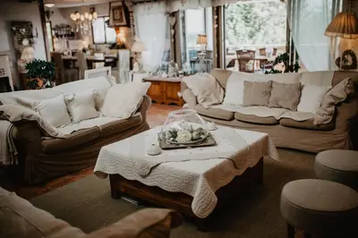 a living room with two couches and a table at Belle demeure de charme in Montels