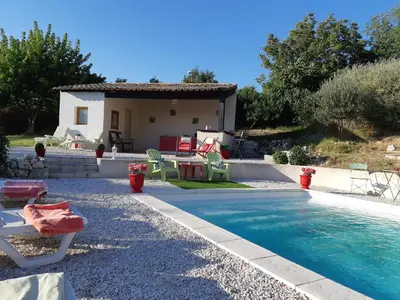 a villa with a swimming pool in front of a house at Belle demeure de charme in Montels