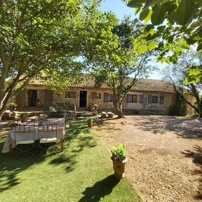 a house with a yard with a table and trees at Belle demeure de charme in Montels