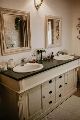 a bathroom with two sinks and two mirrors at Belle demeure de charme in Montels