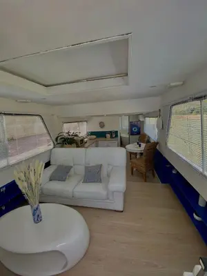 a living room with a white couch and a table at Bateau Mama Mia in Narbonne