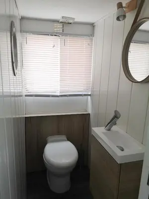 a small bathroom with a toilet and a sink at Bateau Mama Mia in Narbonne