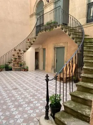 a building with a staircase in front of a building at L’Albizia- Centre -TV WIFI-Cozy in Narbonne