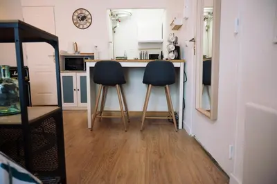 a kitchen with two chairs sitting at a counter at L’Albizia- Centre -TV WIFI-Cozy in Narbonne