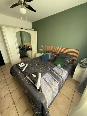a large bed in a bedroom with a ceiling at Villa calme avec piscine in Lavelanet