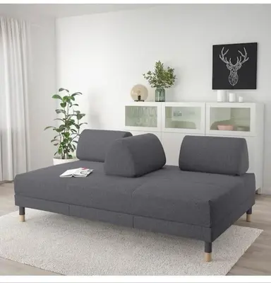 a couch sitting in a living room with at Villa calme avec piscine in Lavelanet