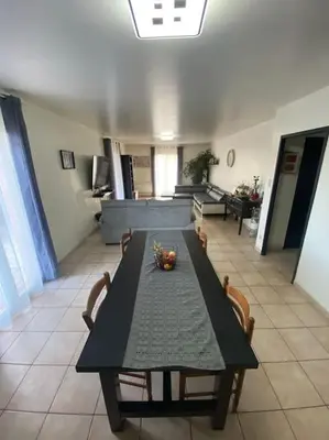 a black table with chairs in a living room at Villa calme avec piscine in Lavelanet