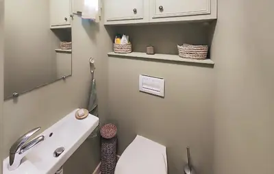 a bathroom with a white toilet and a sink at Nice Home In Saint-Laurent-De-La-Ca in Saint-Laurent-de-la-Cabrerisse