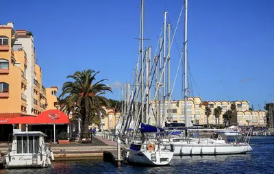 a group of boats docked in a harbor with buildings at Nice Home In Saint-Laurent-De-La-Ca in Saint-Laurent-de-la-Cabrerisse