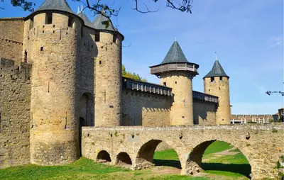 an old castle with two towers and a bridge at Nice Home In Saint-Laurent-De-La-Ca in Saint-Laurent-de-la-Cabrerisse