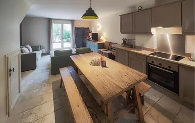 a kitchen with a wooden table in a room at Nice Home In Saint-Laurent-De-La-Ca in Saint-Laurent-de-la-Cabrerisse