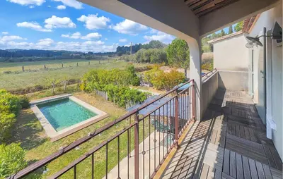 a balcony of a house with a swimming pool at Nice Home In Saint-Laurent-De-La-Ca in Saint-Laurent-de-la-Cabrerisse