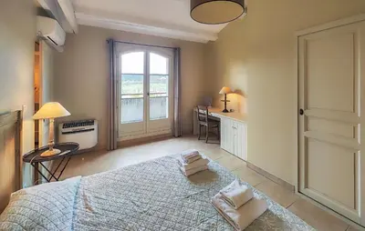 a bedroom with a bed and a desk and a window at Nice Home In Saint-Laurent-De-La-Ca in Saint-Laurent-de-la-Cabrerisse