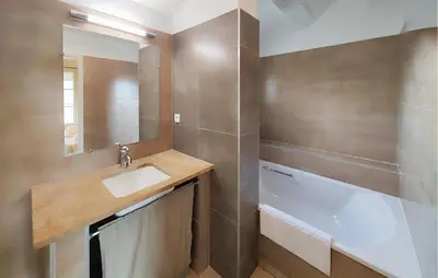 a bathroom with a sink and a bath tub at Nice Home In Saint-Laurent-De-La-Ca in Saint-Laurent-de-la-Cabrerisse