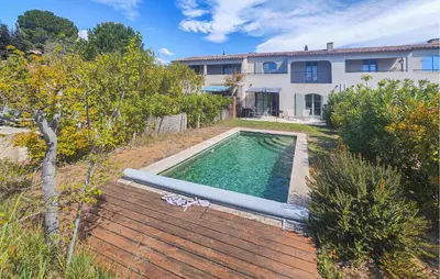 a swimming pool in the yard of a house at Nice Home In Saint-Laurent-De-La-Ca in Saint-Laurent-de-la-Cabrerisse