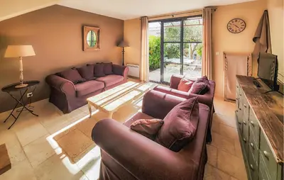 a living room with two couches and a tv at 2 Bedroom Gorgeous Home In Saint-Laurent-De-La-Ca in Saint-Laurent-de-la-Cabrerisse