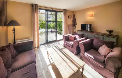 a living room with two couches and a coffee table at 2 Bedroom Gorgeous Home In Saint-Laurent-De-La-Ca in Saint-Laurent-de-la-Cabrerisse