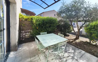 a table and chairs sitting on a patio at 2 Bedroom Gorgeous Home In Saint-Laurent-De-La-Ca in Saint-Laurent-de-la-Cabrerisse